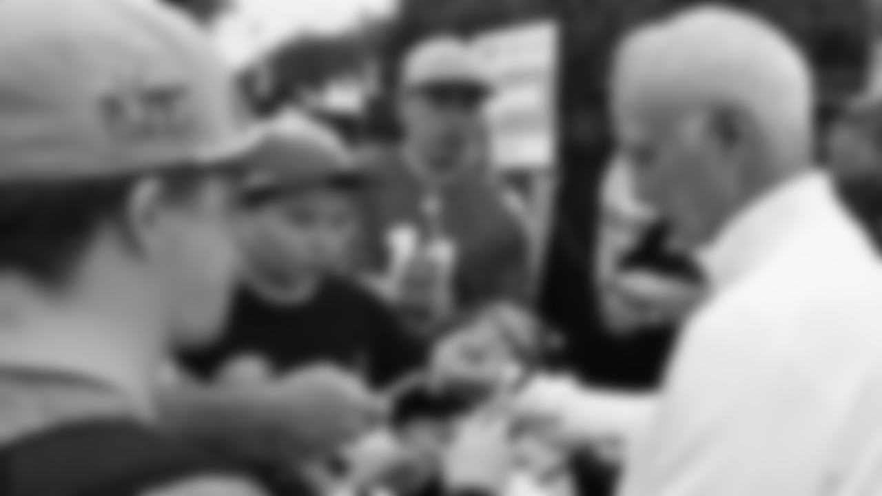 Chairman and CEO Jeffrey Lurie signs autographs.