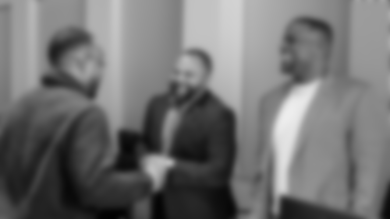 Defensive Backs Coach Christian Parker laughs with Vice President of Football Operations Jeff Scott and Vice President of Player Personnel Charles Walls.