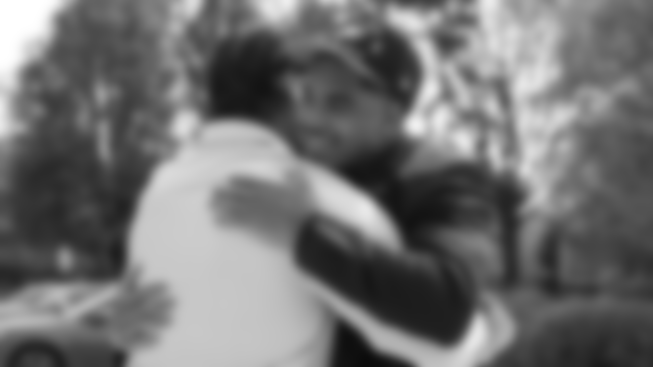 Jihaad Campbell embraces Linebackers Coach Bobby King.
