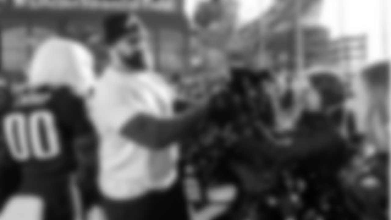 Jason Kelce high-fiving Eagles Cheerleaders McKenna and Gracie