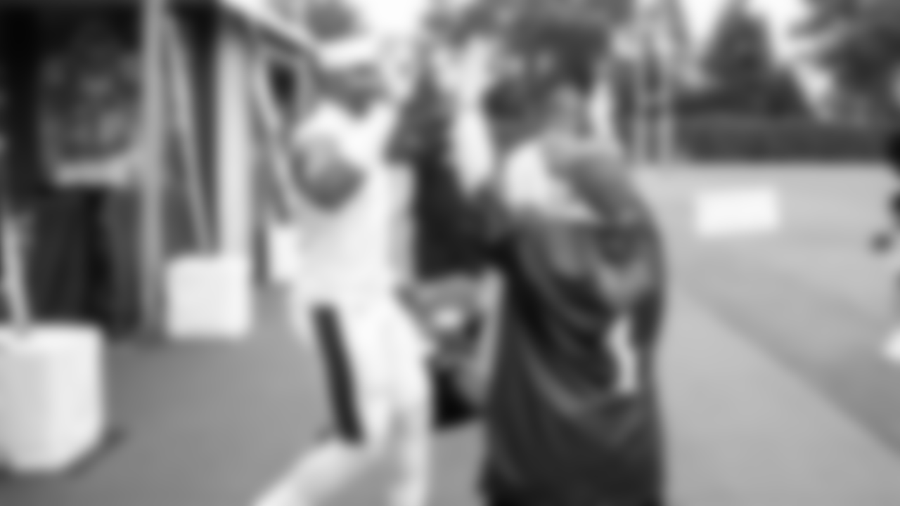 Jalen Hurts high-fiving a fan.