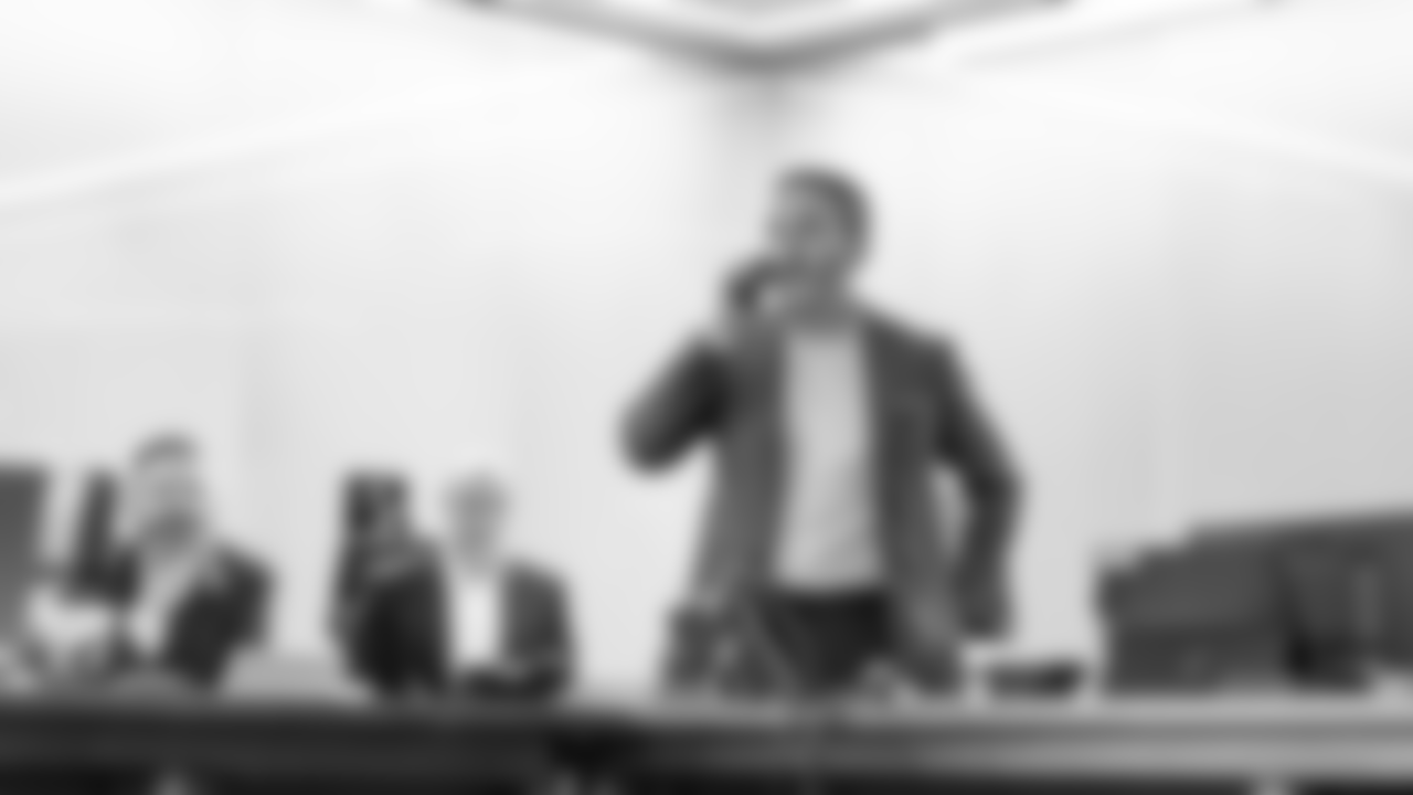 Howie Roseman on the phone while Senior Personnel Director/Advisor to the General Manager Matt Russell and Senior Vice President/Tertiary Football Executive Bryce Johnston watch.