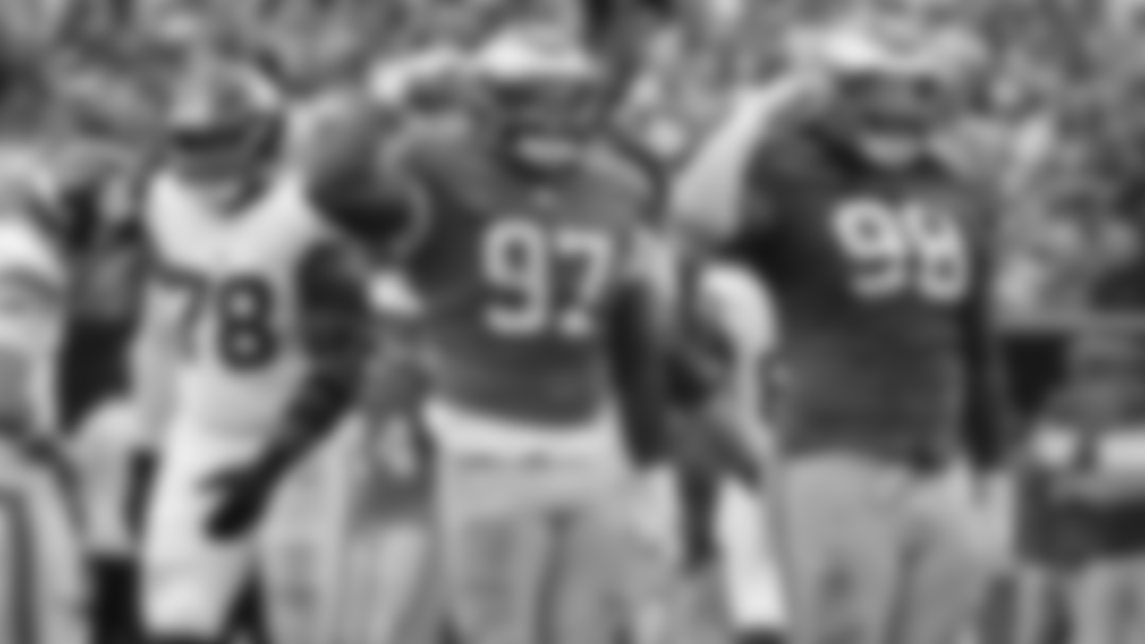 Moro Ojomo and Jalen Carter salute after a big play against the Giants.