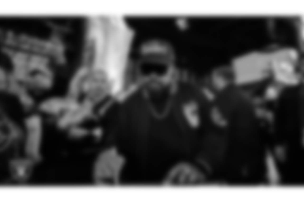 Rapper Ice Cube signs the Al Davis Memorial torch before the Las Vegas Raiders' regular season home game against the New York Jets at Allegiant Stadium.