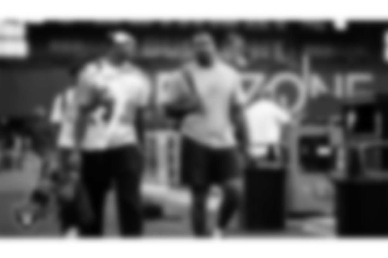Las Vegas Raiders defensive end Tyree Wilson (9) and defensive tackle Zach Carter (93) arrive to the preseason away game against the Arizona Cardinals at State Farm Stadium.