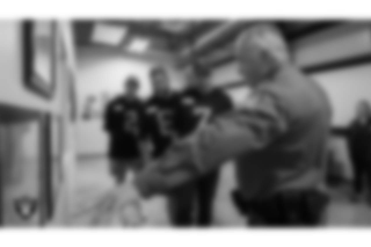 Las Vegas Raiders kicker Daniel Carlson (2), defensive end Malcolm Koonce (51) and quarterback Brian Hoyer (7) tour the William Fortye K-9 Operations Center.