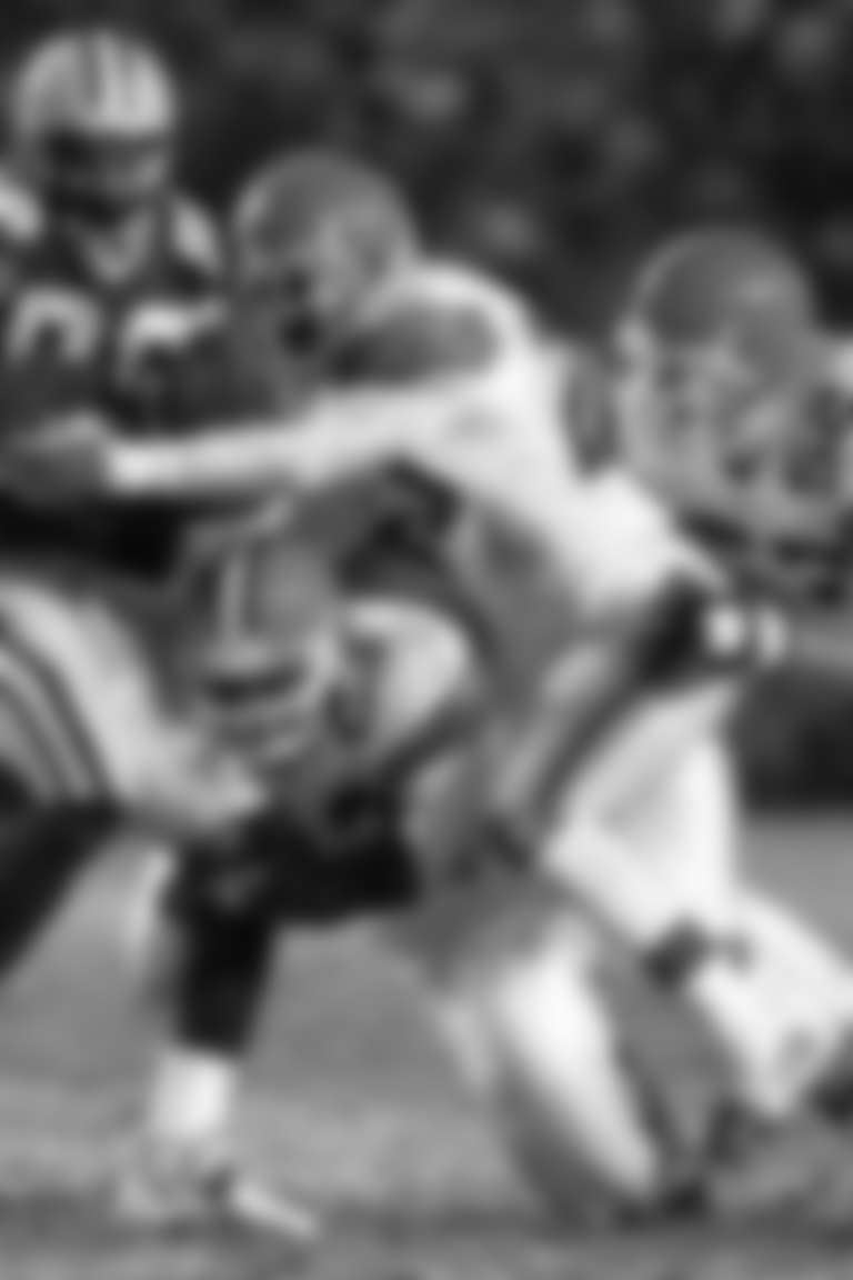 Cleveland Browns' Devin Bush (23), Earl Little (20) and Brant Boyer (52) try to stop Green Bay Packers' receiver Antonio Freeman after making a reception in the third quarter Sunday, Dec. 23, 2001, in Green Bay, Wis. (AP Photo/Andy Manis)