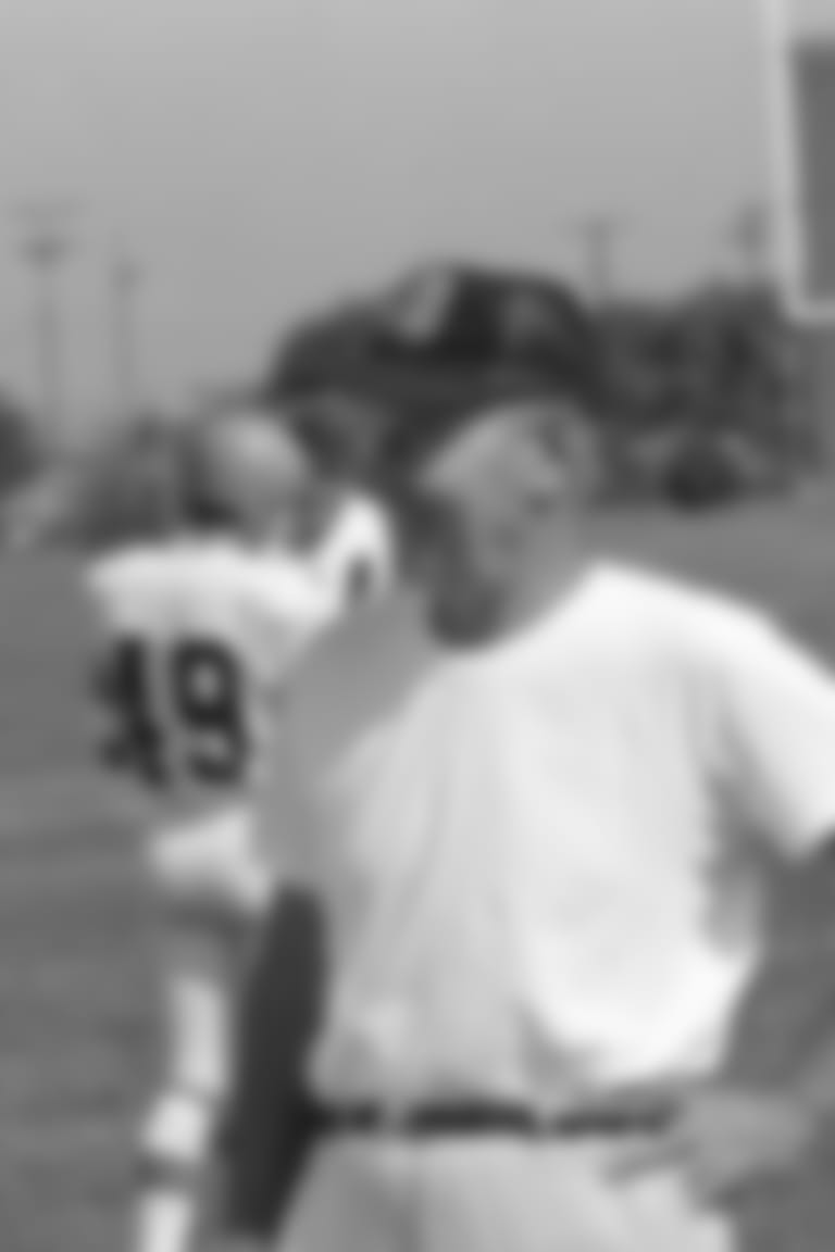 Cincinnati Bengals' head football coach Paul Brown, right, talks with two of his quarterbacks during a workout on Aug. 21, 1970, at their training camp in Wilmington, Ohio. At left is Dave Lewis, also a punter, and Sam Wyche, center. (AP Photo/Gene Herrick)
