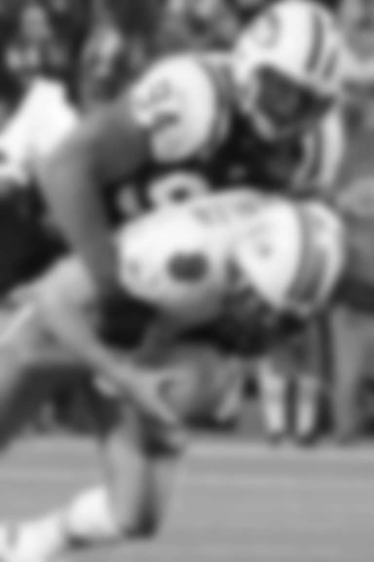 Defensive end John Abraham leaps through the air to sack Jay Fiedler during the Jets 41-14 win over the Miami Dolphins on Monday Night Football, November 1, 2004.AbrahamJactionXXVIII