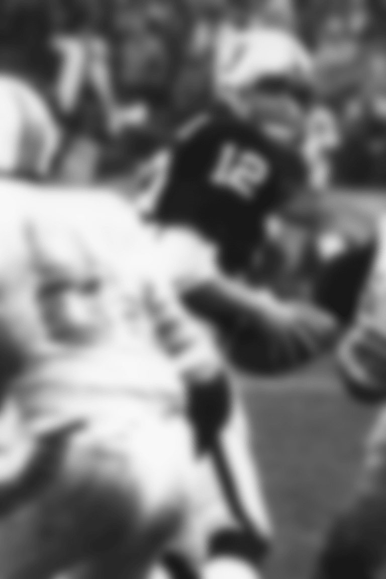 Oakland Raiders quarterback Ken Stabler (12) drops back for the infamous "Sea of Hands" play during the AC Divisional Playoff game against the Miami Dolphins at Oakland-Alameda County Coliseum, Saturday, December 21, 1974, in Oakland, Calif. The Oakland Raiders won 28-26.