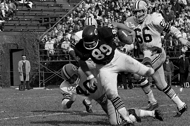 image: News The Tight End TrendHall of Fame tight end Mike Ditka carries the football.