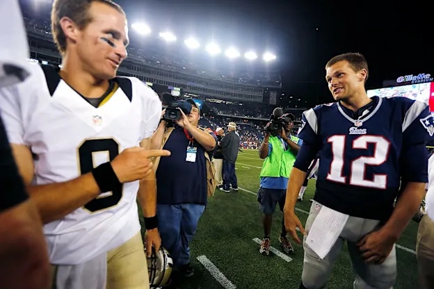 image: News Race to the top: Brady’s battle with Brees for the NFL’s most hallowed recordIn this Aug. 9, 2012, file photo, New Orleans Saints quarterback Drew Brees (9) points at New England Patriots quarterback Tom Brady (12) after the Patriots defeated the Saints 7-6 in an NFL preseason football game in Foxborough, Mass.